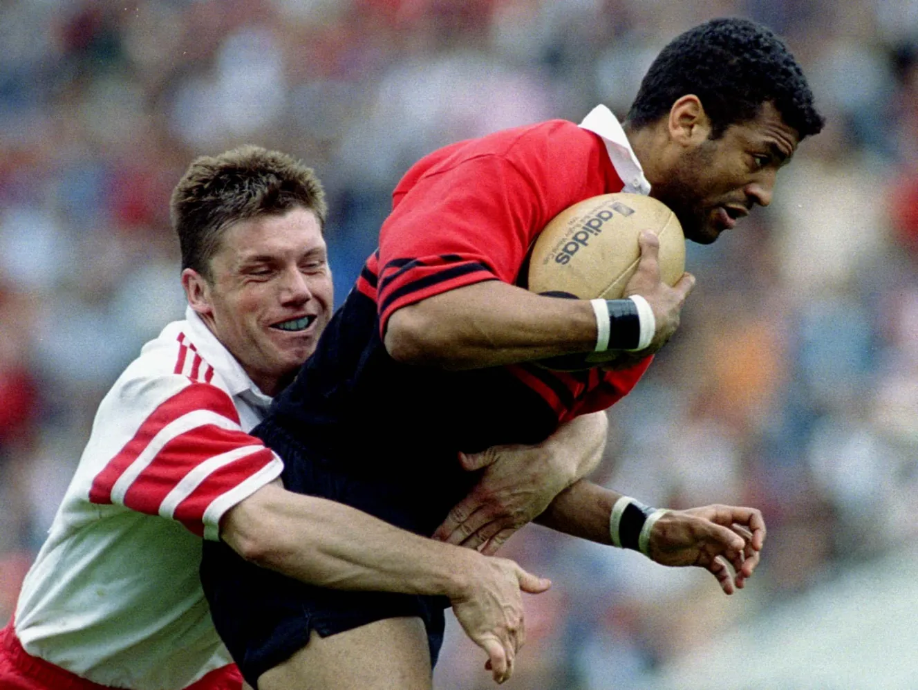 Toulouse's Emile Ntamak is tackled by Dax's Daret during the French rugby league semifinal match.