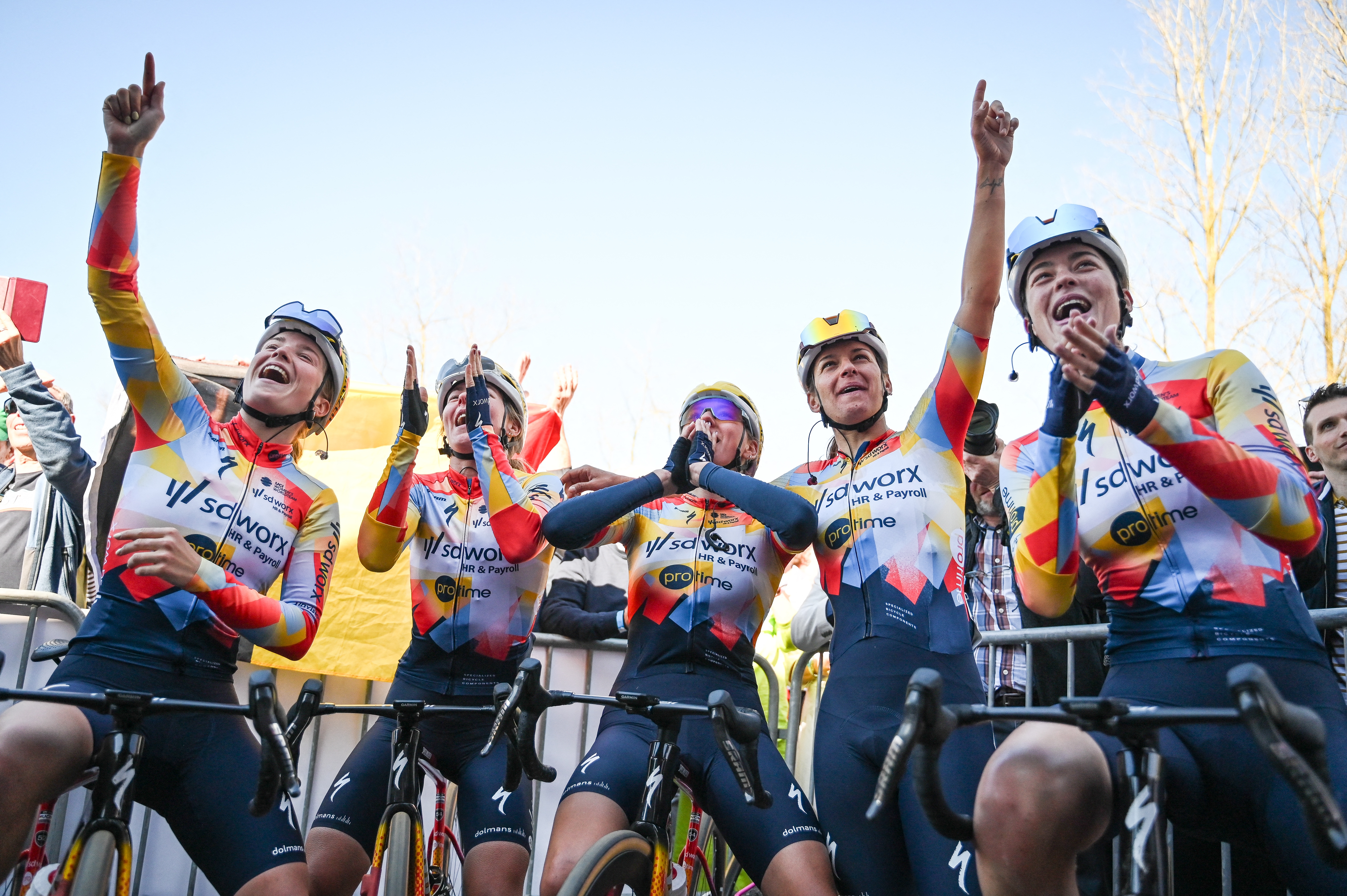 SD Worx-Protime riders celebrate the victory of their teammate Lotte Kopecky (not pictured) after the one-day 'Nokere Koerse' women's cycling race, 133.3km from Deinze to Nokere, on March 18, 2026. (Photo by ELIAS ROM / Belga / AFP) / Belgium OUT