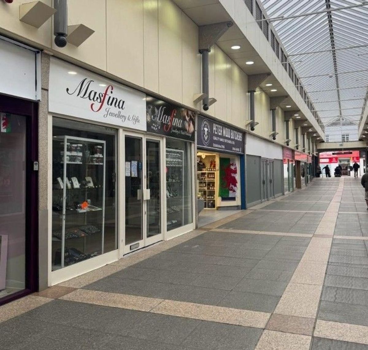     The historic market doors are closed, shop windows are empty, and the lights are off in many establishments