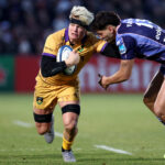 Northampton Saints' Henry Pollock fends off a tackle from Bordeaux Bègles' Nicolas Depoortere during the January 2026 European Champions Cup match.