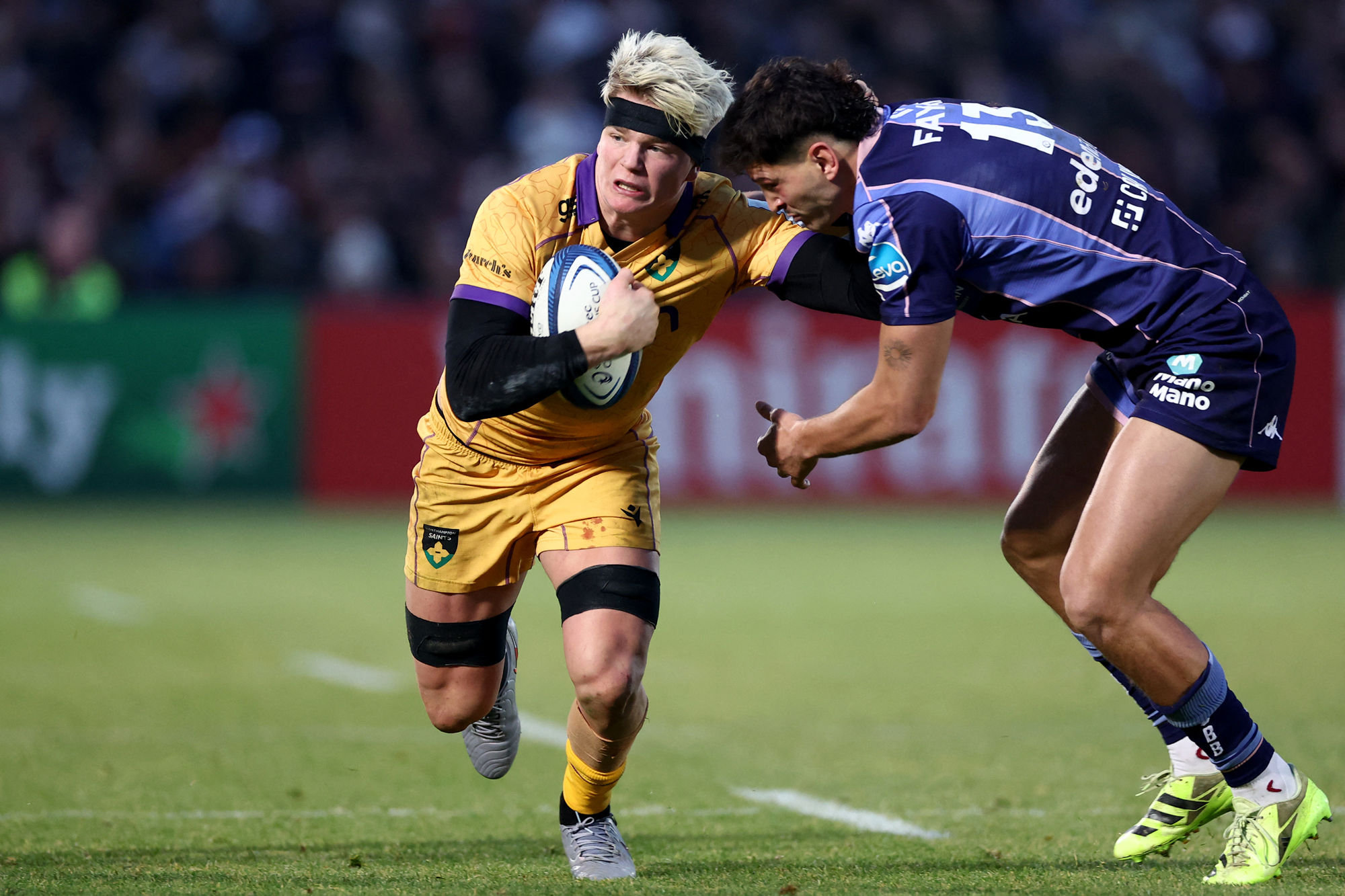 Northampton Saints' Henry Pollock fends off a tackle from Bordeaux Bègles' Nicolas Depoortere during the January 2026 European Champions Cup match.