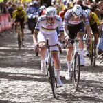 Tadej Pogacar climbs up cobbles